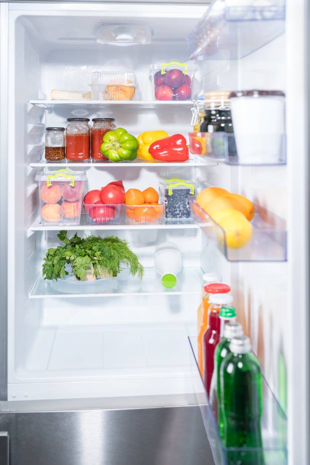 Open fridge with fresh fruit and vegetables