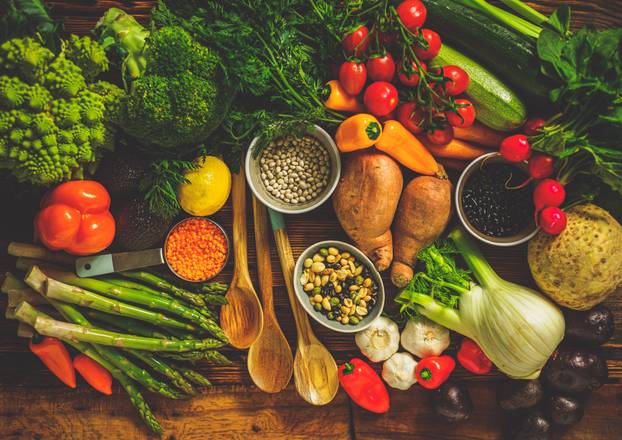 Assortment of fresh vegetables on wooden background