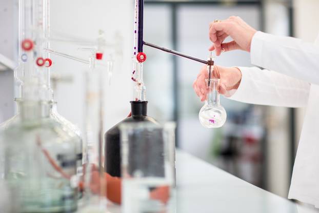 Lab worker's hands while at work at a research center in a lab, 