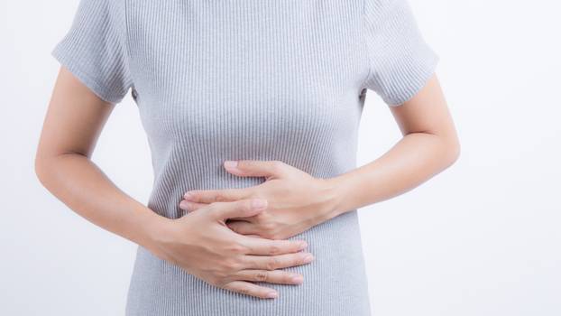 Close ups of Asian women with abdominal pain on white background