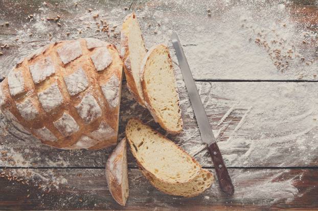 Bakery concept background. White sliced bread and knife