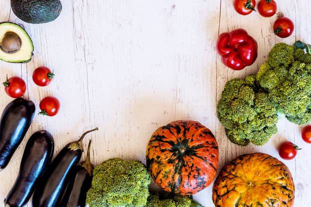 Vegetarian food. Different vegetables on a white wooden background. Top view