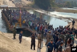 In this photo released by Royal Thai Army, more than 250 people from 20 nations who were reportedly rescued from alleged scam centers in Myanmar, as they crossed into Thailand's Tak province, Feb. 12, 2025.