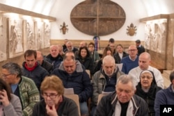 Faithful attend a Mass for the health of Pope Francis at an underground chapel under St. Peter's Basilica at the Vatican on March 1, 2025.